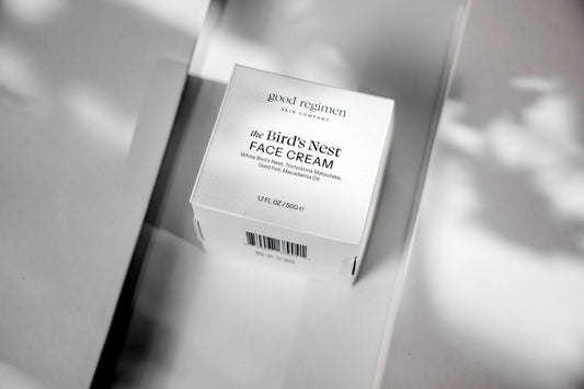 Good Regimen The Bird’s Nest Face Cream box in a minimalist black-and-white skincare setting, featuring White Bird’s Nest, Tricholoma Matsutake, Gold Foil, and Macadamia Oil.