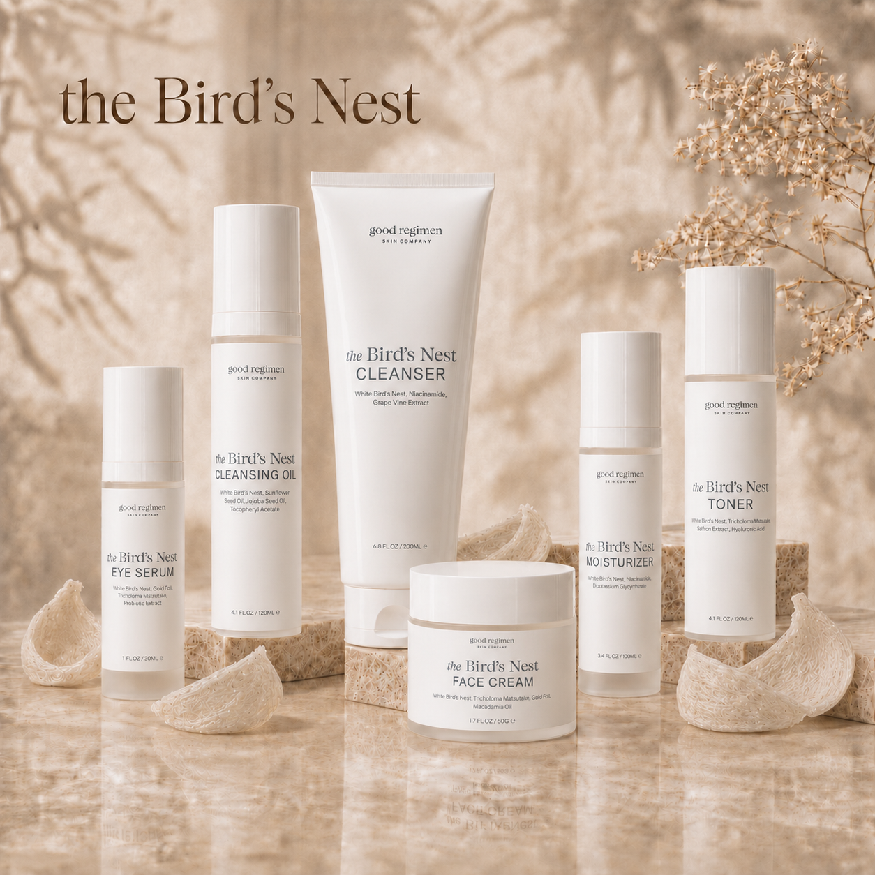 The Bird’s Nest Collection by Good Regimen Skin Company featuring cleansing oil, cleanser, toner, eye serum, moisturizer, and face cream with real White Bird’s Nest accents on a luxury marble display for hydrated, radiant, healthy-looking skin.